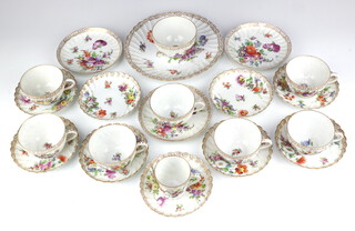 A 20th Century Dresden part tea and coffee set comprising 7 tea cups, 3 saucers, 1 coffee cup, 6 saucers, 3 small plates, 1 large plate and a sugar bowl decorated with spring flowers 