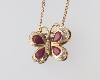 A yellow metal 9k ruby and diamond butterfly pendant on a 9ct yellow gold 44mm chain 4.7 grams 