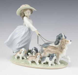 A Lladro Privilege Group of a girl with dogs and puppies 6784, 25cm, boxed