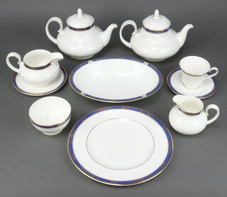 A Royal Doulton Cathay pattern H5140 tea and dinner service comprising 12 tea cups (7 seconds, 1 is cracked, 1 slightly smaller in size), 12 saucers (3 seconds), 10 small plates and 1 similar, 6 soup bowls (4 seconds), 6 dinner plates (all seconds), 2 vegetable dishes, 2 oval meat dishes (both seconds), 2 teapots (both seconds), 2 cream jugs (both seconds), 2 milk jugs (1 second), 2 sugar bowls (1 second), 2 saucers