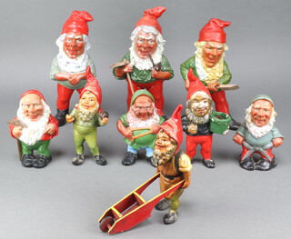 A collection of Heissnner painted ceramic figures of gnomes including a standing gnome 30cm, ditto 29cm, and 28cm, four standing gnomes 22cm, another 15cm and one pushing a wheel barrow 20cm 