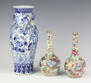 A Chinese blue and white vase with floral and bird decoration 25cm (chips to lip), together with a pair of famille rose baluster vases decorated with dragons amongst flowers 17cm 