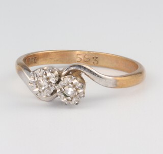 An Edwardian yellow metal 9ct, 2 stone illusion diamond set crossover ring, 2.1 grams, size N 