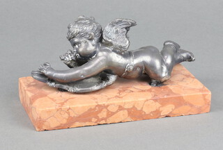 A 19th Century spelter and marble paperweight decorated a reclining cherub on a pink marble base 8cm h x 15cm w x 8cm d 