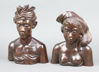 A pair of Bali carved hardwood portrait busts of a lady and gentleman 27cm x 24cm 