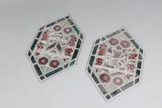 A pair of diamond shaped lead glazed stained glass panels with armorial decoration 54cm x 33cm 