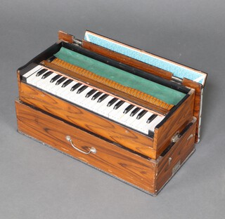 A street/missionary organ in a simulated rosewood case 26cm h x 54cm w x 25cm d 