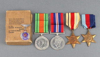 A group of 4 Second World War medals comprising 1939-45 Star, Africa Star, Defence and War medal together with an enamelled Royal Engineers Sweetheart brooch and original un-named posting box 