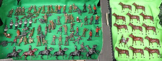 A collection of metal figures of cavalry horses, mounted cavalrymen, WWI soldiers and other military figures 