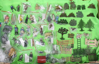 A collection of Britains, Timpo and F G Taylor & Sons farm accessories including gates, fencing, trees, water pumps, scarecrow, seated milkmaid with pail and other figures