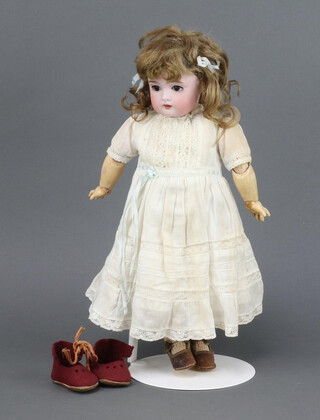 An Edwardian German porcelain headed doll with articulated body, the head with open and shutting eyes and open mouth with 4 teeth  incised A Germany 152, 32cm 