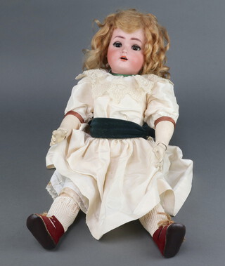 Simon Halbig, a porcelain headed doll with sleep eyes and open mouth with 4 teeth