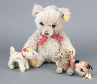 A Steiff bear no.011535 28cm, unboxed, a miniature Steiff dog no.1308/00 7cm, ditto bear 20202/11 9cm and a Steiff bird 6cm 