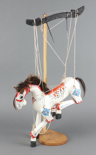 A white painted wooden jointed puppet in the form of a horse 24cm h x 31cm x 9cm 