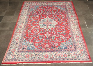 A North Persian red and blue ground carpet with central medallion within multi row border 424cm x 297cm 