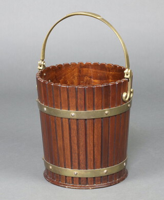 A reproduction Georgian mahogany and brass banded peat bucket with swing handle 24cm h x 32cm diam. 