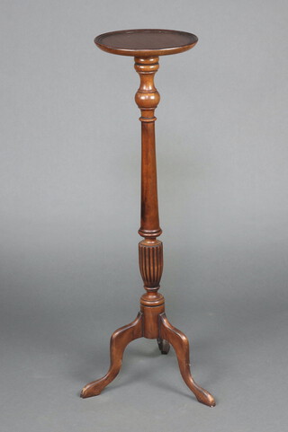 A Georgian style turned mahogany torchere, raised on pillar and tripod base 108cm h x 29cm diam. 