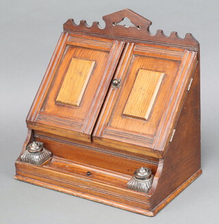 A Victorian oak wedge shaped stationery box with stepped fitted interior, the base fitted glass inkwells 33cm h x 35m w x 20cm d 