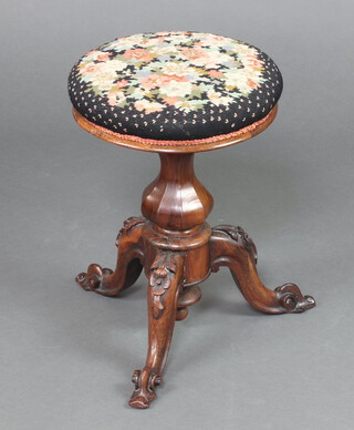 A Victorian carved rosewood adjustable piano stool with Berlin woolwork seat, on cabriole supports 48cm h x 35cm diam. 