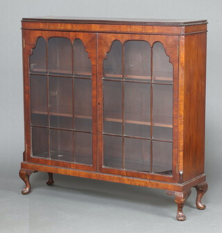 A 1930's Chippendale style mahogany display cabinet fitted shelves enclosed by astragal glazed panelled doors, raised on cabriole supports 119cm h x 121cm w x 30cm d 