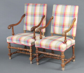 A pair of 19th Century, 17th Century style, oak open arm chairs, the seats and backs upholstered in check material, raised on turned supports 111cm x 61cm x 54cm (seat 29cm x 35cm)  