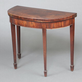 A Georgian mahogany demi-lune card table with hinged lid, raised on square tapered supports, spade feet 74cm h x 94cm cm w x 43cm d 