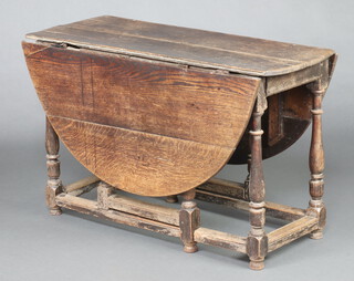 An 18th Century oval drop flap gateleg dining table, raised on turned supports 71cm h x 114cm w x 46cm d 