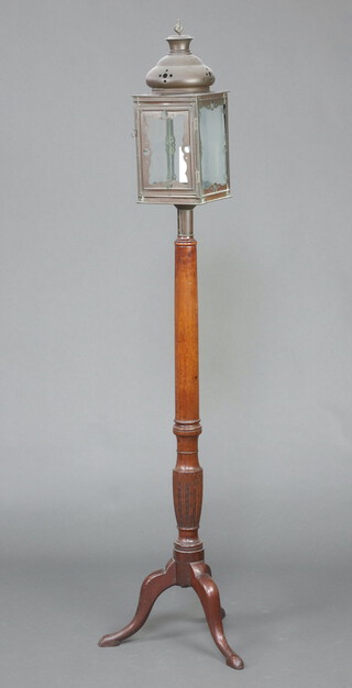 A Georgian turned mahogany bedpost converted to a standard lamp with square copper light housing, raised on a tripod base 178cm h x 20cm w x 20cm d 