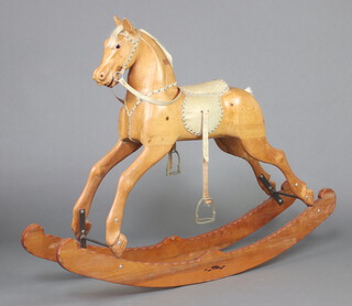 A carved light oak rocking horse 115cm h x 150cm w x 28cm d 