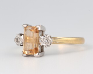 An 18ct yellow gold citrine and diamond ring the centre emerald cut stone approx. 1ct, the 2 brilliant cut diamonds each approx. 0.03ct, size N, 3.4 grams 