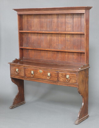 An 18th Century oak dresser base fitted 1 long and 2 short drawers with brass lion mask ring drop handles with an associated later raised back fitted 2 shelves and with moulded cornice 192cm h x 155cm w x 40cm d 