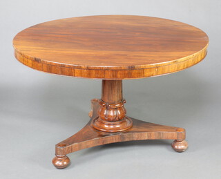 A William IV circular rosewood snap top breakfast table raised on a turned column and triform base ending in bun feet 73cm h x 119cm diam.  