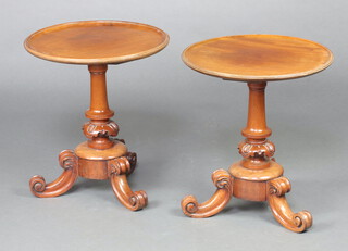 A pair of Victorian circular mahogany dish top wine tables, raised on turned column and scrolled feet 50cm h x 45cm diam.   