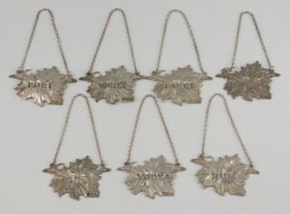 A set of 7 cast silver spirit labels with leaf pattern in the Georgian manner - Gin, Claret, Port, Vodka, Rum, Brandy and Whisky, London 1968, 124 grams 