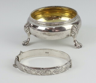 A Victorian silver salt with shell knees and paw feet, London 1861, together with a silver bangle 89 grams