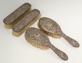 A silver 4 piece brush set Birmingham 1926 and 1927 comprising 2 hair brushes and 2 clothes brushes