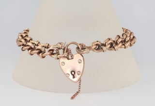 A yellow metal 9ct fancy link bracelet with heart padlock, 20cm, 17.6 grams 