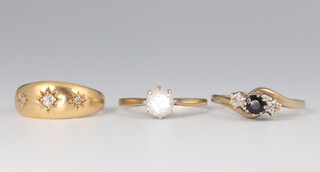 An 18ct yellow gold ring size J, 3 grams, two 9ct gem set rings size J and N 2.7 grams 