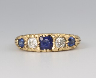 An 18ct yellow gold sapphire and diamond ring, the 3 sapphires 0.60ct, the 2 diamonds 0.25ct, 6 grams, size R 