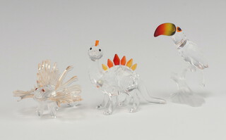 Three Swarovski Crystal  figures -Toucan sitting on a branch 8cm, baby dinosaur 7.5cm and a Japanese Lion Fish 5.5cm, all boxed  