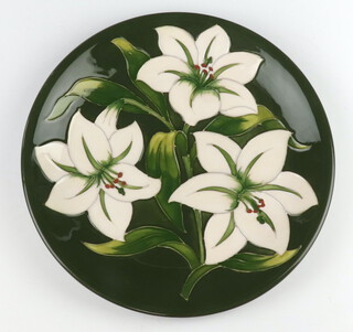 A Moorcroft plate decorated "Bermuda Lily", designed by Walter Moorcroft,  signed, 26cm 