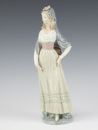 A Lladro figure of a Spanish lady 32cm, together with a Lladro figure of a seated gentleman and hound 26cm