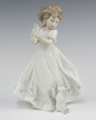 A Lladro figure of a girl holding a kitten, a 2003 Events Creation, dated 5/10/03, signed and numbered 6941, 22cm, boxed 