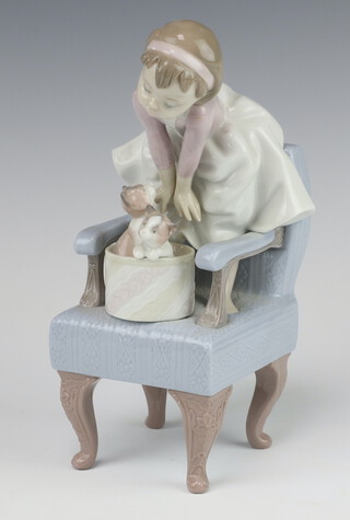 A Lladro 1998 Event Figurine 6512 of a young girl standing on a chair with a basket of kittens before her, boxed 24cm 