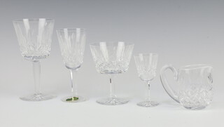 A set of Waterford Crystal Lismore pattern glasses comprising 3 red wine glasses, 8 sherries, 3 coups, 6 liqueurs and a water jug 