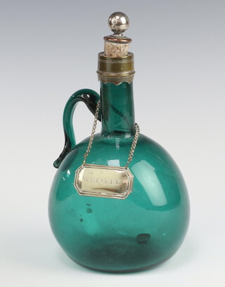 A 19th Century green glass bottle with plated metal mounts and a whisky decanter label 22cm 