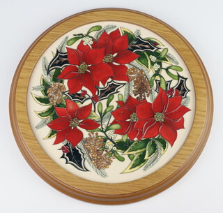 A Moorcroft circular tile decorated "Festive Feelings", designed by Kerry Goodwin, painted by Helen Dale, 2015, 25cm 