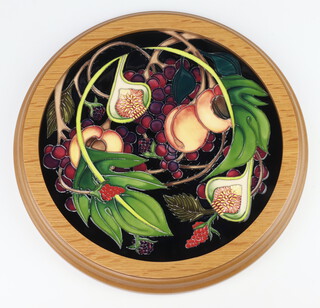 A Moorcroft circular tile decorated "Queens Choice", designed by Emma Bossons, impressed marks dated 2000, decorated by Kerri 25cm 