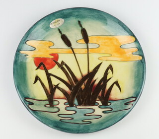 A Moorcroft plate decorated "Reeds at Sunset", designed by Philip Richardson, impressed marks, 26cm 