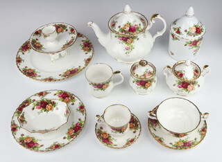 An extensive Royal Albert Old Country Roses, tea, coffee and dinner service comprising 4 coffee cups (all seconds), 7 saucers, 5 tea cups (1 second), 4 saucers, 4 mugs (3 seconds), a coffee pot (second), a large teapot, a breakfast teapot, a lidded sugar bowl (second), 2 cream jugs (seconds), milk jug, 6 two handled bowls (all seconds), 6 large saucers (2 seconds) biscuit barrel and cover, 2 sugar bowls (1 second), 2 preserve pots and lids (seconds), two teapot lids, 6 dinner plates (5 seconds), 5 side plates (seconds), a sandwich plate, 2 oval meat plates (1 second), 4 small dishes (all seconds), 4 egg cups, 2 cup stands (seconds), sauce boat and stand (seconds), a hand bell, spoon rest, bon bon dish, jardiniere (second), 2 condiments, casserole and cover, 2 oval dishes, 4 handled knives, a butter dish and cover, 2 shaped dishes (seconds), 4 small dessert bowls (seconds), 4 large dessert bowls, sandwich plate (second), 2 tier cake stand (lacking handle and a second), 3 dishes (seconds), 2 circular dishes, a basket (second), a swan, rectangular dish and a set of 6 cake knives   